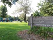 Picture of Jack Yost Park entrance sign and play equipment